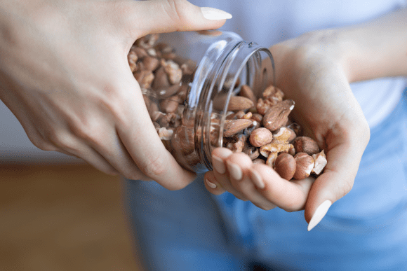 Pouring a jar of nuts into hand