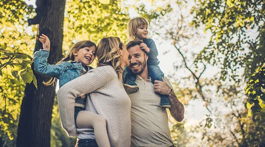 Family walking through a forest