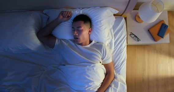 man sleeping on bed