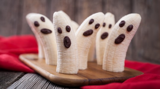 Bananas halved with chocolate drops ghost shaped