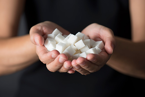 Hands full of sugar cubes