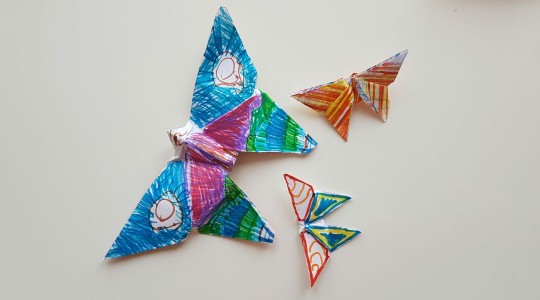 Three colourful, homemade origami butterflies