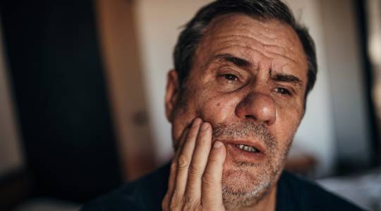 Man with tooth pain from missing teeth