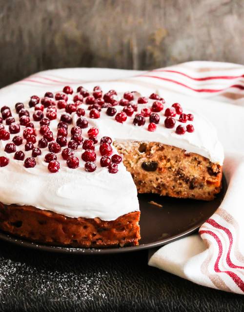 Festive sugar-free berry cheesecake topped with red berries and cream cheese icing