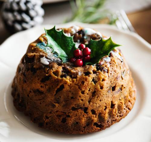 Sugar free Christmas pudding topped with a sprig of holly