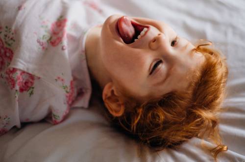 Child lying down in bed