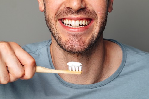 World Oral Health Day - Fluoride toothpaste man smiling