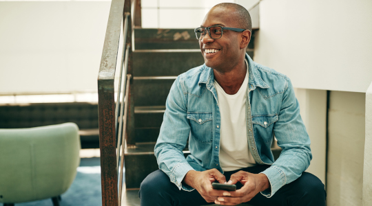 Man sitting on stairs smiling