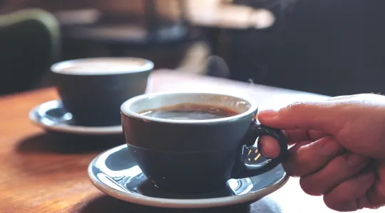 hand-picking-up-cup-of-coffee