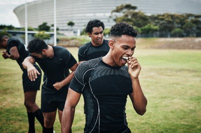 men playing sports and wearing gum shields