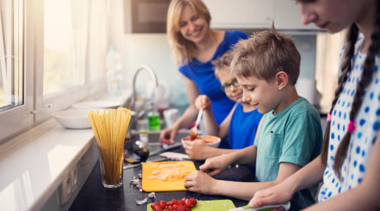 Mum and children preparing a healthy meal together