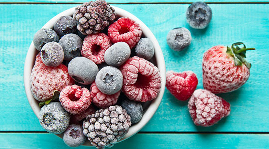 Large bowl of frozen fruit dusted in ice