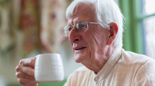 grandfather holding the coffee mug