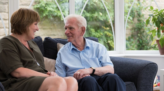 old people smiling at each other