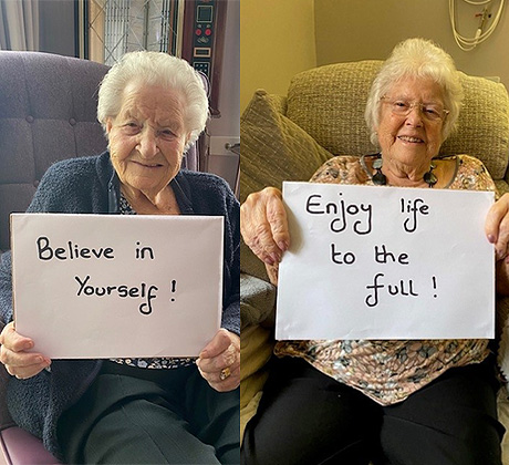 Ashby Court residents holding signs saying believe in yourself and enjoy life to the full