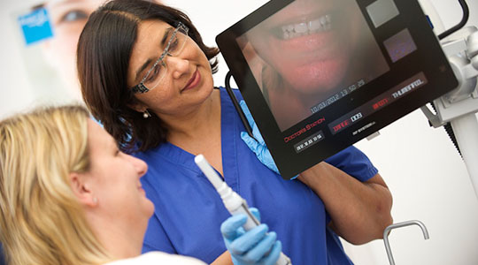 Dentist discussing picture of patients teeth