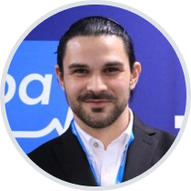 image of the author, Zach, a male presenting person with dark features and short facial hair
