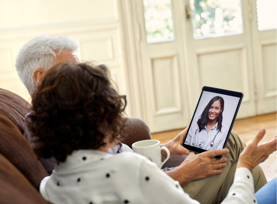 Couple using tablet for online medical consultation with doctor via video call healthcare