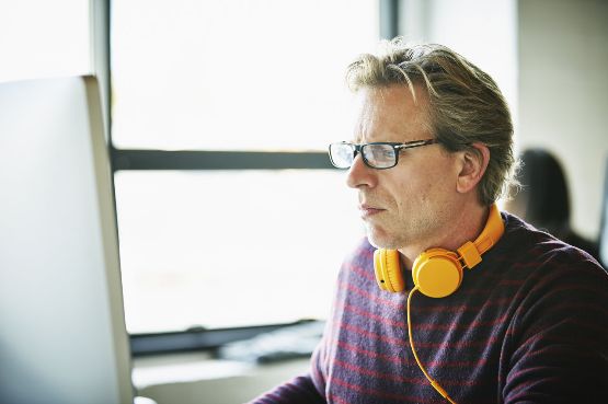 A man sat at his computer