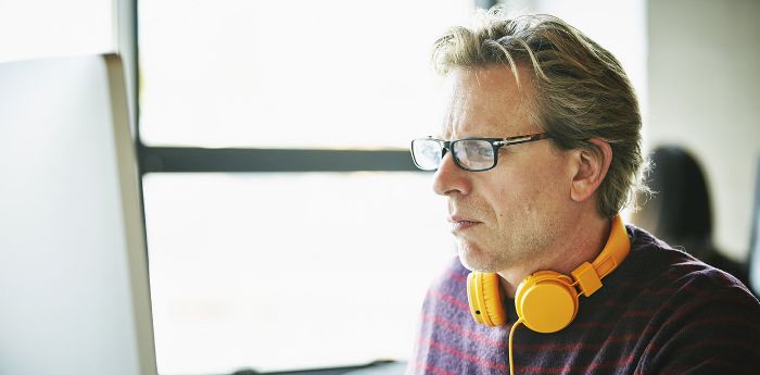 A man sat at his computer