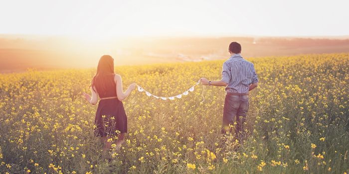 Couple walking in a field of flowers