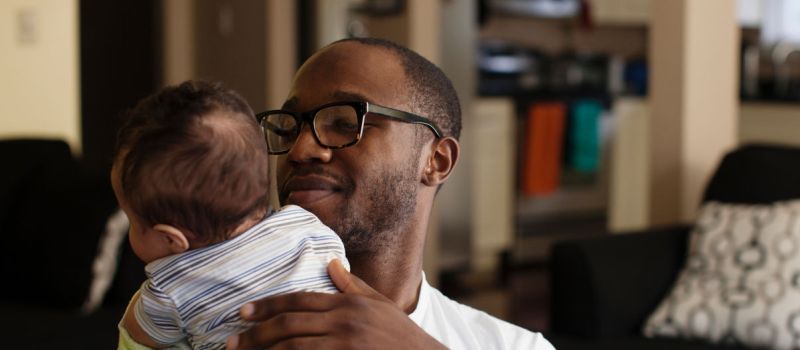 Image of a man holding his baby