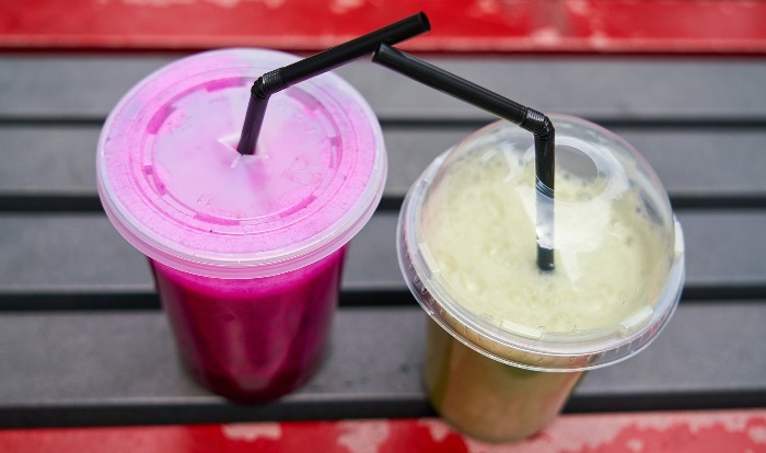 Two takeaway cups of juice