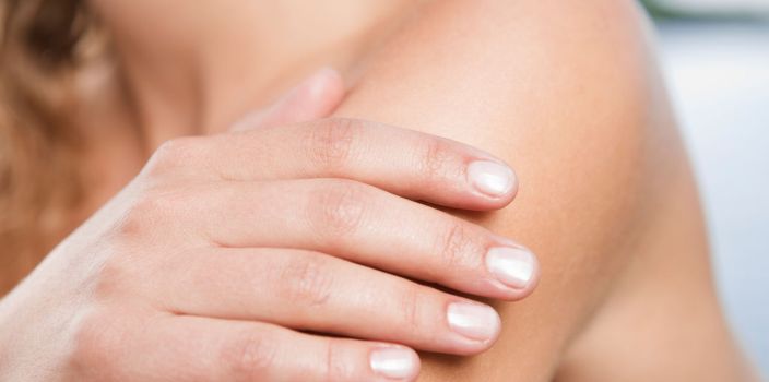 A woman's hand on her bare arm