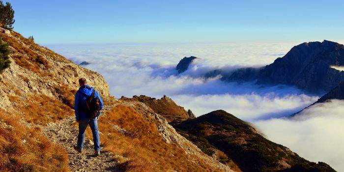 A man walking in the moutnains above the clouds