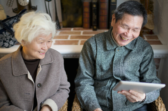 Image of an older couple browsing on an iPad