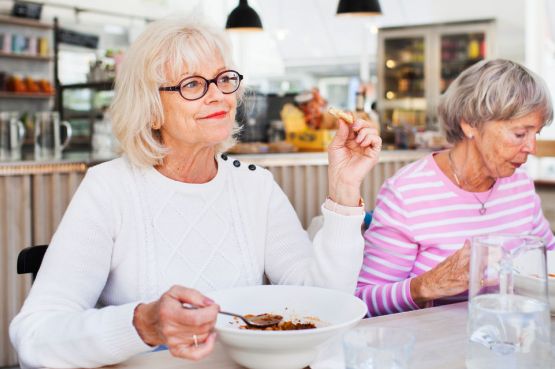 Senior ladies eating lunch in a restaurant