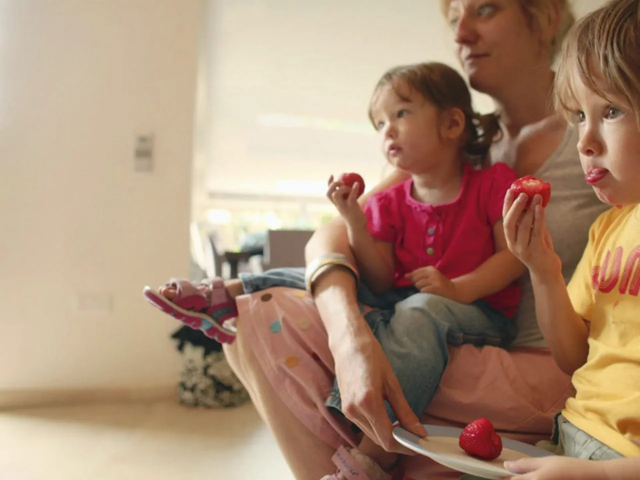 An image showing a family eating strawberries An image showing a family eating strawberries