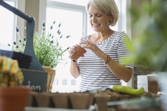 Image of an older woman gardening